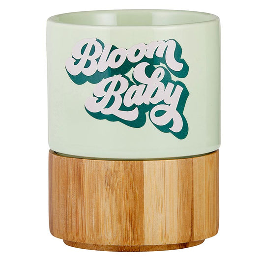 "Bloom Baby" Petite Ceramic Mug with Bamboo Base. The ceramic mug is in light green.