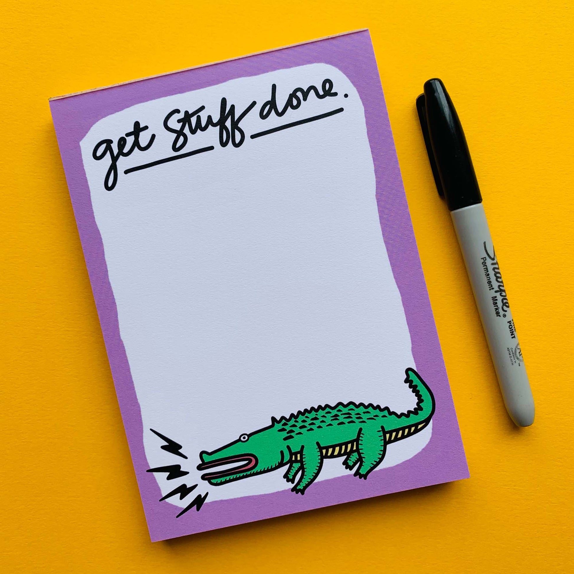 Another flat-lay image of the notepad next to a sharpie. The "Get Stuff Done" text is in all lowercase and written in a script style.