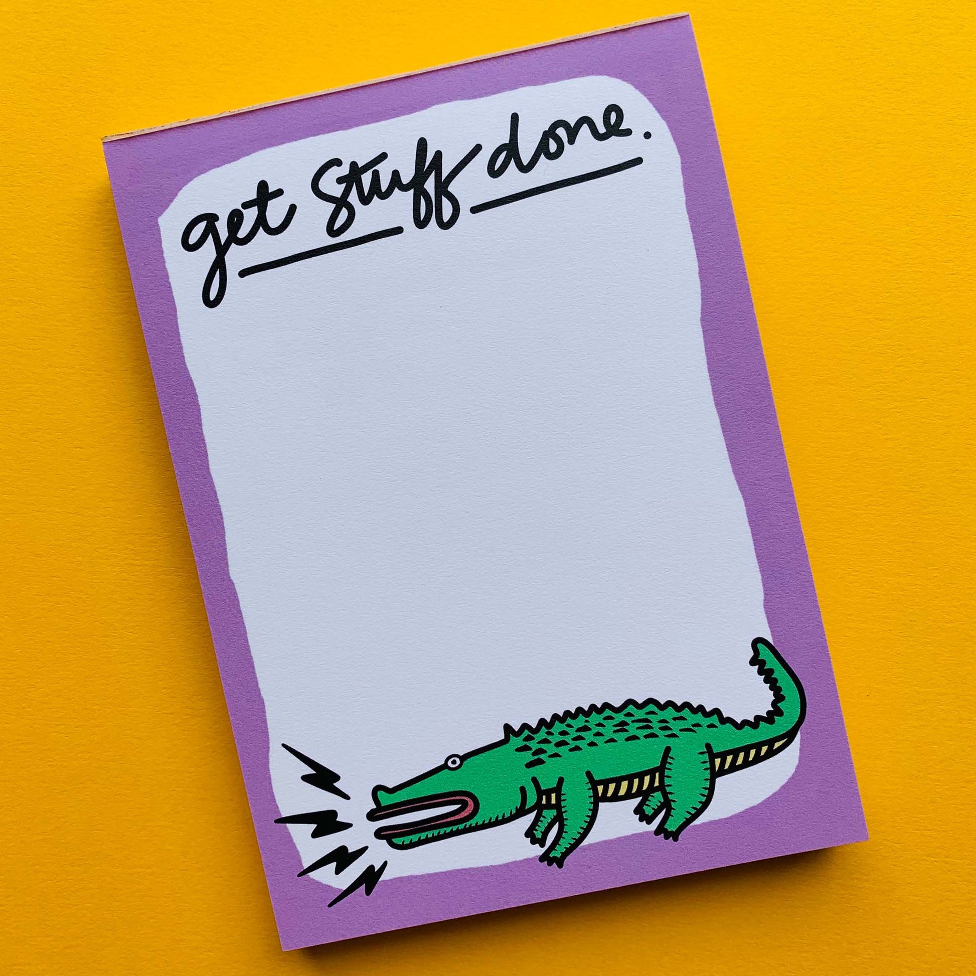 Flat-lay of the Get Stuff Done notepad with a drawn alligator available on Kangyco.com.