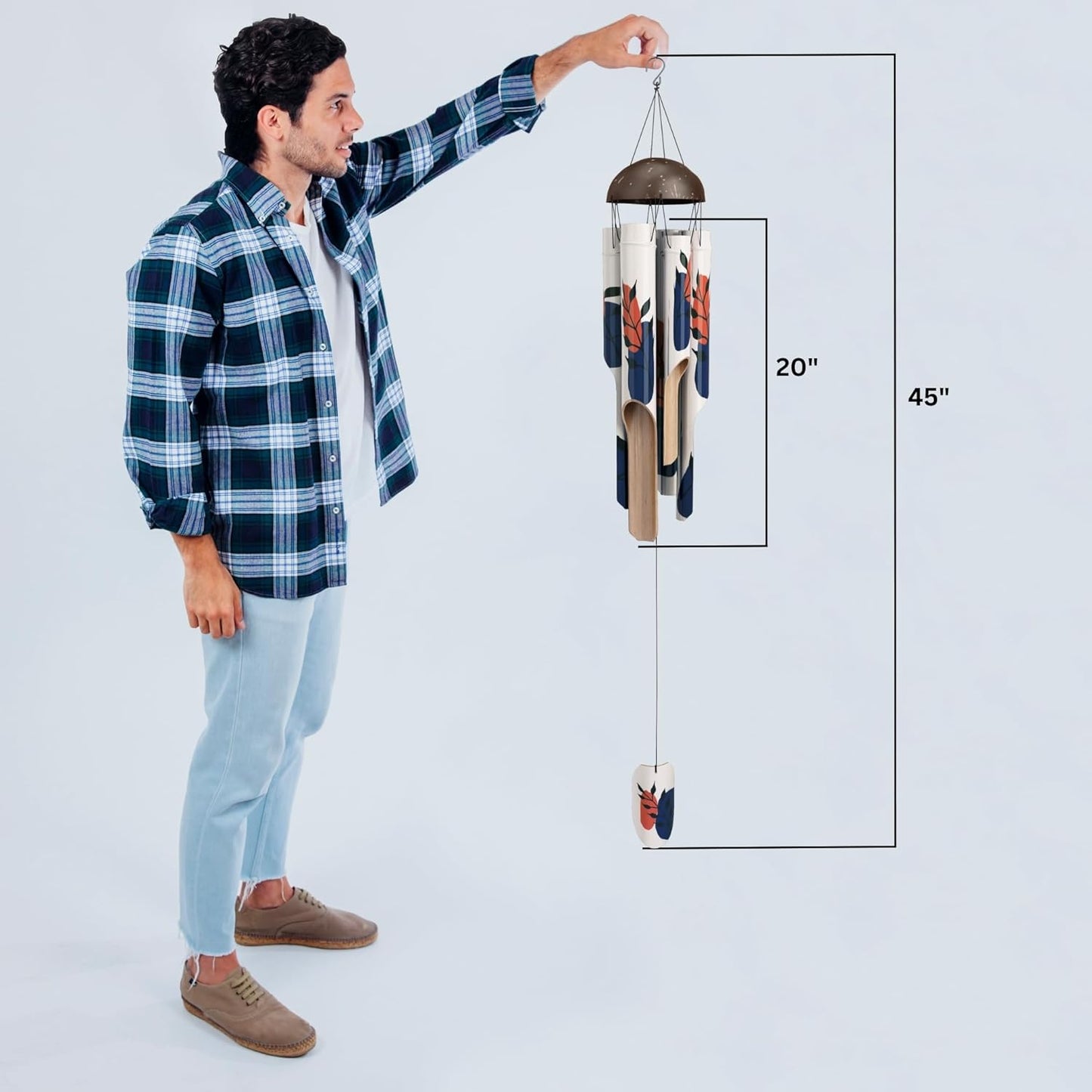 Man holding up the bamboo wind chime with the sizing written. The bamboo wind chime is 20" the entire thing from Stainless Steel Hook to the Wind Catcher is 45".