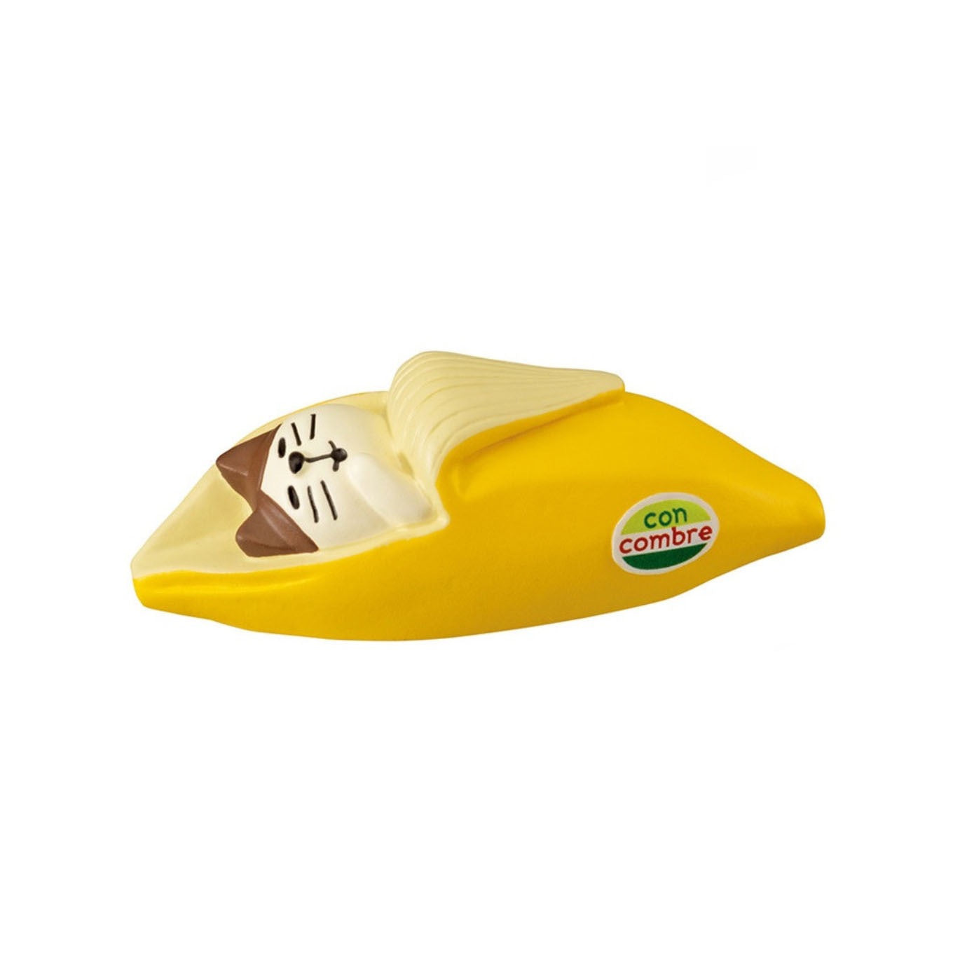 Pawsome figurines #248 of a cat sleeping inside of a banana with a sticker on the banana that reads "con combre".