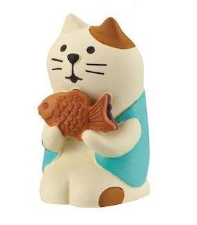 The Pawsome figurines #4 of a cat holding a  Taiyaki.