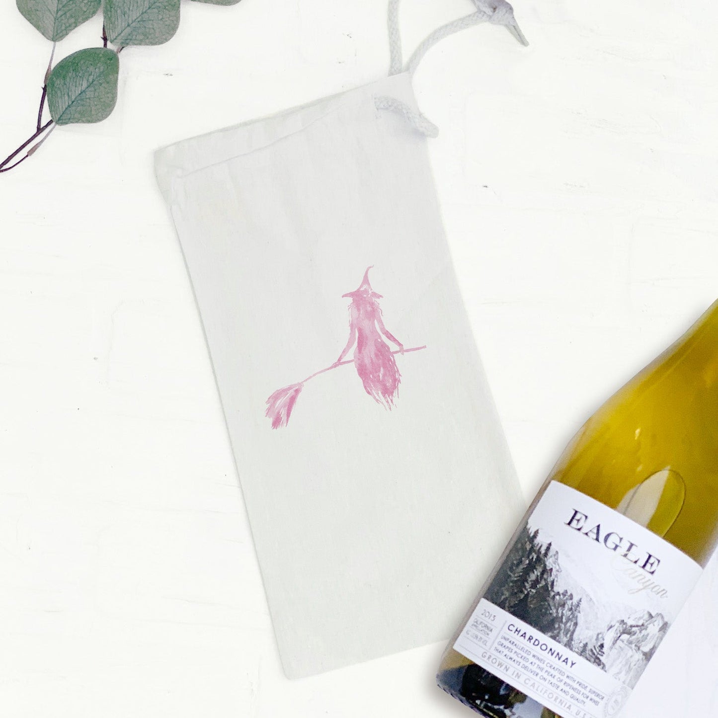 Pink Witch silhouette sitting on a broom on a canvas wine bag available on Kangyco.com.