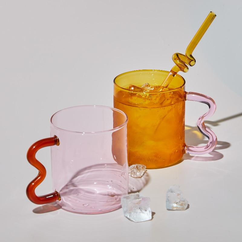 The translucent yellow (style B) and red glass mug (style A) (straw not included).