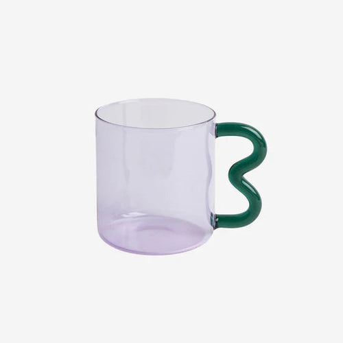 Translucent purple glass mug with a wavy handle in green.