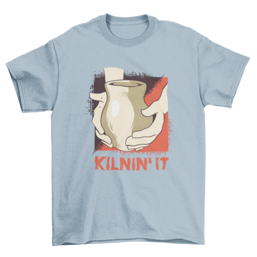 Kilnin' It T-shirt in Light Blue, hands on a ceramic vase.