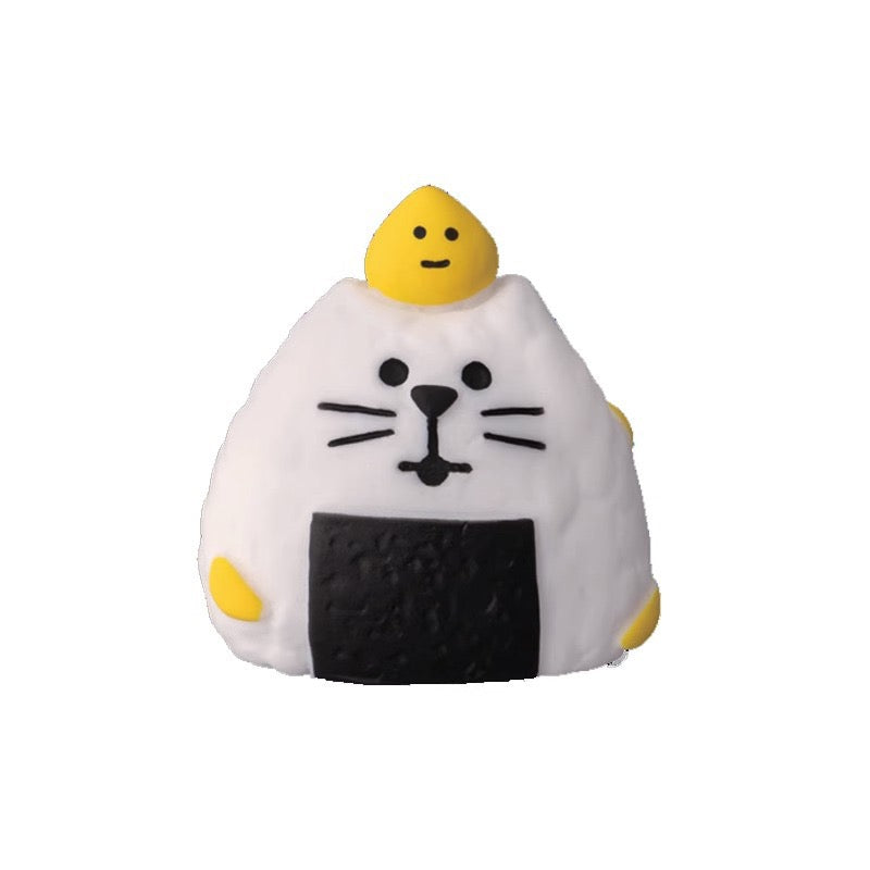 A Pawsome Onigiri Figurine with a dollop of yellow with a smiley face and the cat face on the rice of the Onigiri.