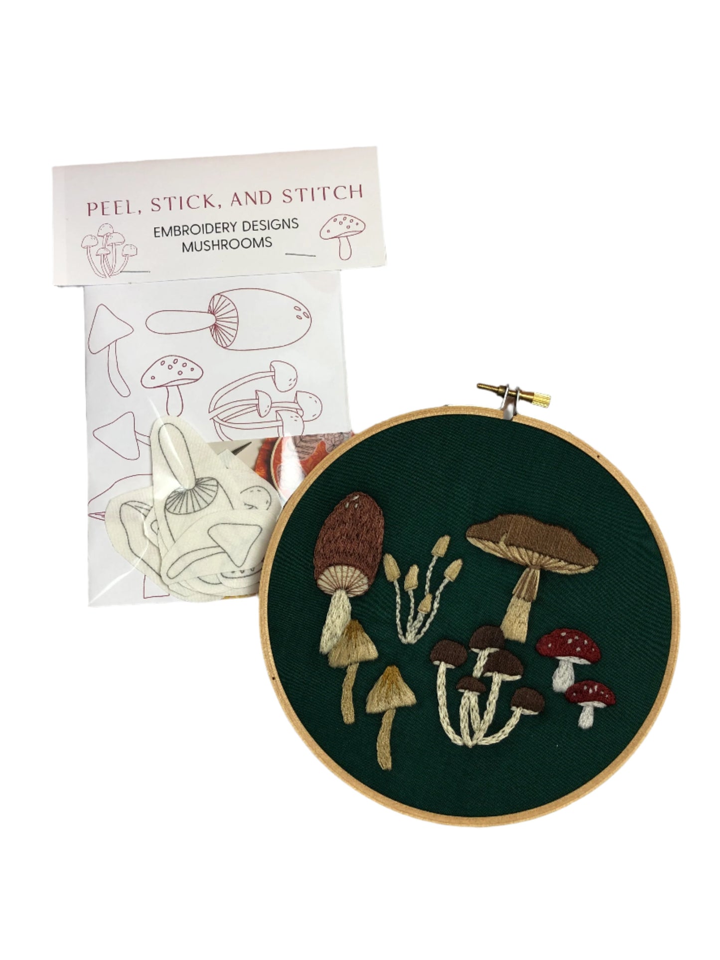 The finished Peel, Stick, and Stitch: Embroidery Designs Mushrooms and the package with mushroom pattern contents.