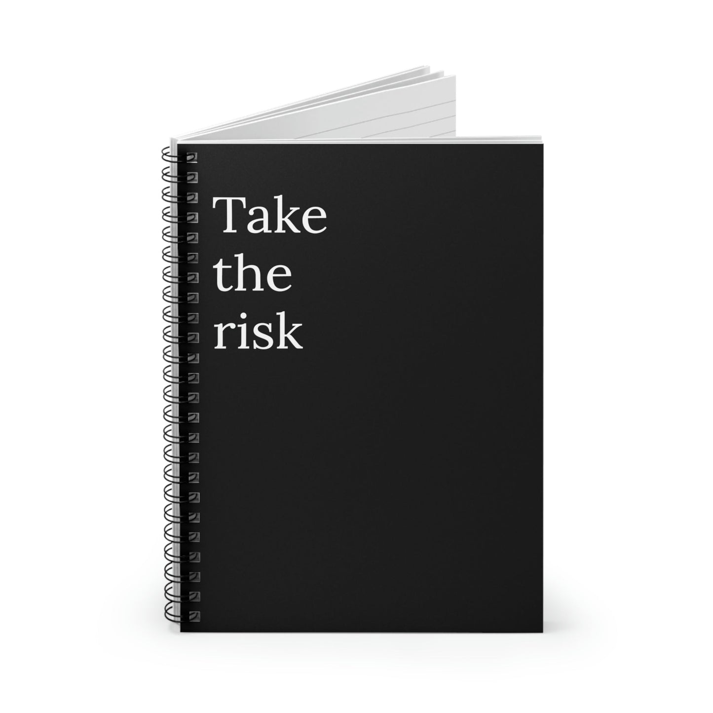 Black cover notebook with the text "Take the risk" on the front. Notebook is lined.