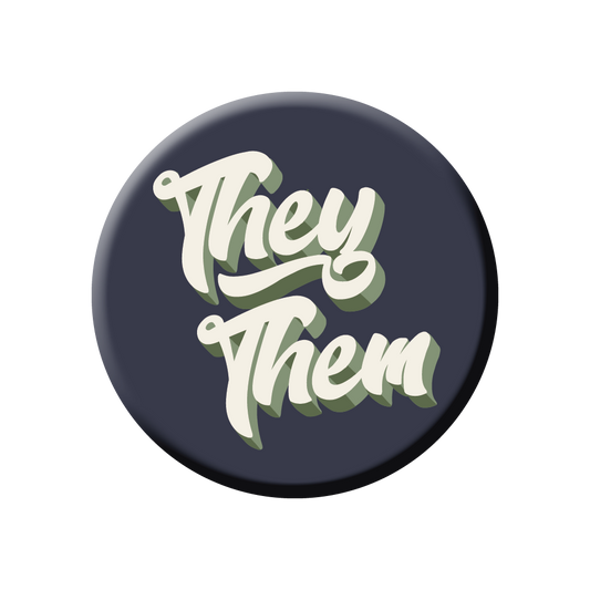 An enamel pin with the text "They Them" written in cursive.