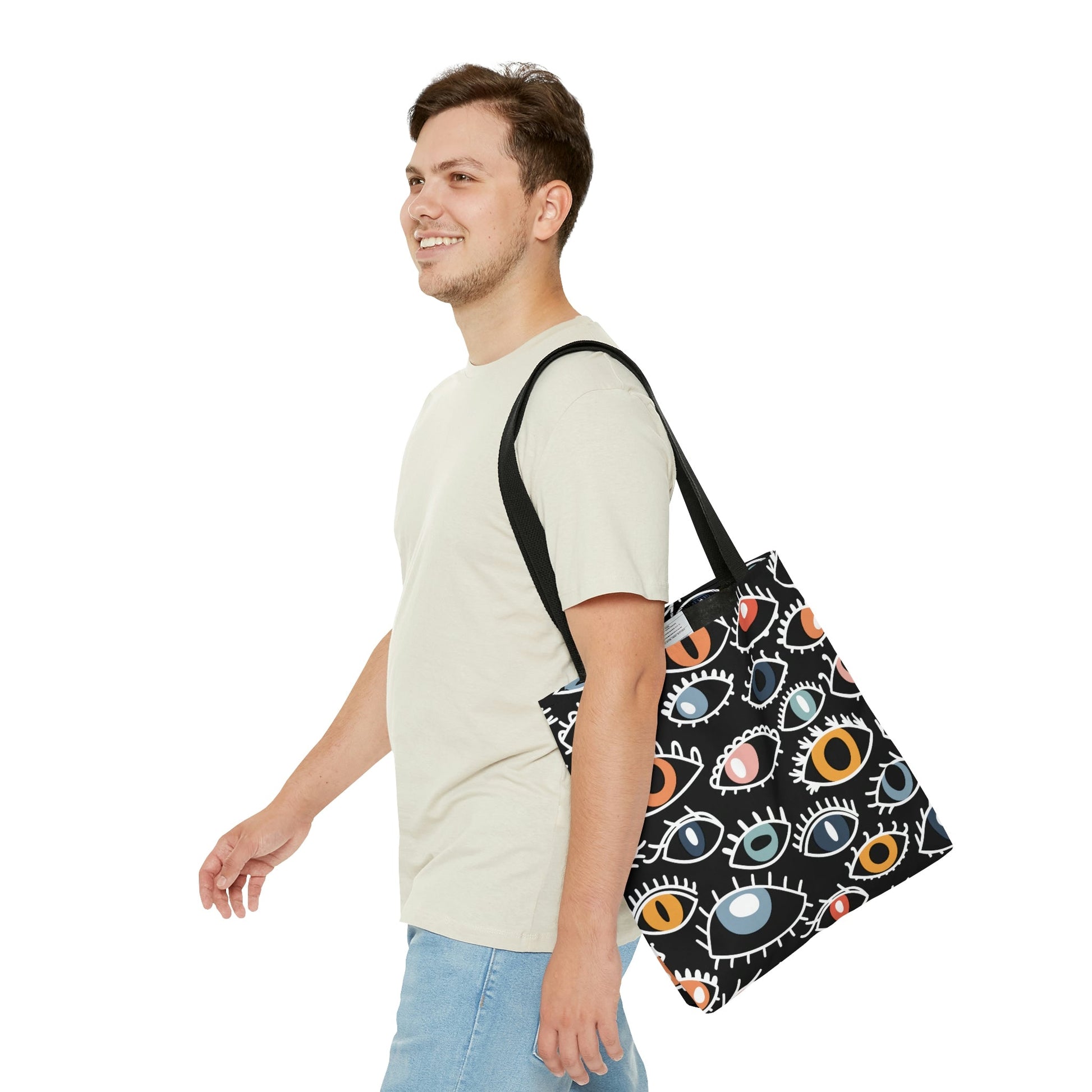 A man wearing the Egyptian Eye Tote Bag.